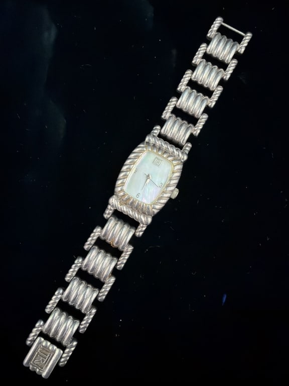 Judith Ripka Sterling Silver Quartz Watch: Distinctive ribbed bracelet design and textured bezel. Dial is Mother Pearl and marked 925. See pictures, condition appears good. No refunds given.