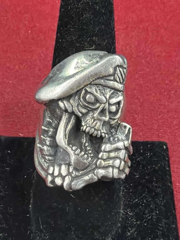 Sterling Skull Ring: Features a skull in a beret pulling a grenade pin with his teeth. Ring is a size 9 and weighs 18.7g. Condition appears good. No refunds given.