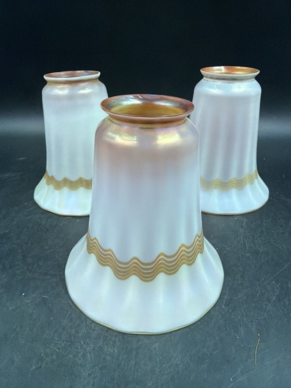 Vintage Quezal Art Glass Lamp Shade: Total of 3 in this lot. White calcite exterior with gold Aurene iridescent decoration and wave pattern near ruffled rim. Measures 5 1/4" and 2", diameter is 5" and fitter ring is 2". Condition is