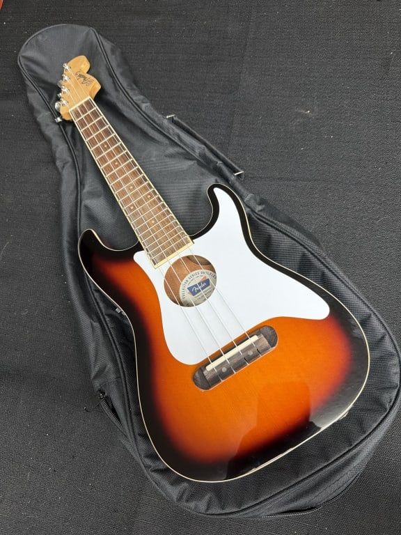 Fender Ukulele: Comes with soft case. Condition is consistent with age and use, appears good. See pictures. No refunds given.