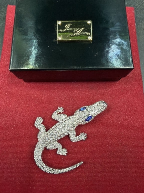 Isabella Adams: Crystal Kid Gator paperweight featuring crystals on rhodium -plated body and sapphire colored eyes. Condition is good, see pictures. No refunds given.