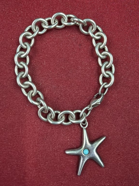 Sterling Tiffany and Co Bracelet: Starfish chain link bracelet with small turquoise stone. Part of the Elsa Peretti Collection for Tiffany. Marked 2003 Tiffany and Co .925. Weighs 34.6 g and condition appears good. See pictures, no