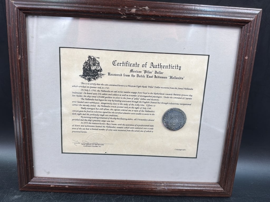Shipwreck Coin with Certificate: Neat treasure coin in frame with certificate. Shipwreck Mexican Pillar Dollar from the Dutch East Indiaman "Hollandix". Frame measures 11 1/4" x 13 1/4". Condition is good, see pictures. No refunds