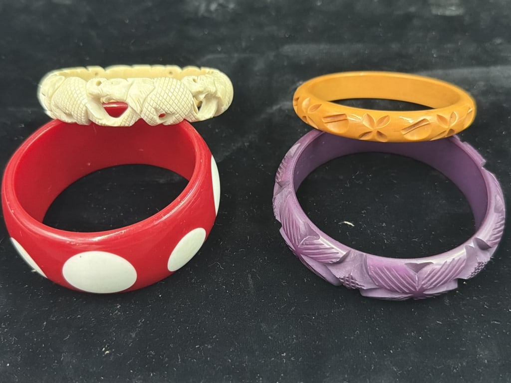 Vintage Bangle Bracelets: Total of 4 in this lot. There is 3 bracelets one is polka dots (2.181"), butterscotch (2.203")and purple lucite ( 2.474") . The other is elephants (2.023"). Condition appears good, see pictures. No