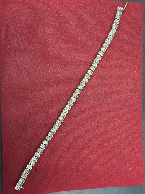10kt Gold Diamond Tennis Bracelet: Lovely piece that weighs 8.8g and measures 7". The diamonds are est 1/16 of a carat. See pictures, condition is good. No refunds given.