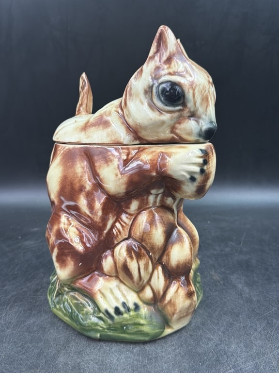 Vintage McCoy Pottery Squirrel Cookie Jar: Brown and cream glaze with green leaf details on base. Piece marked on bottom and measures about 10 1/2"h. Condition is good, see pictures. No refunds given.
