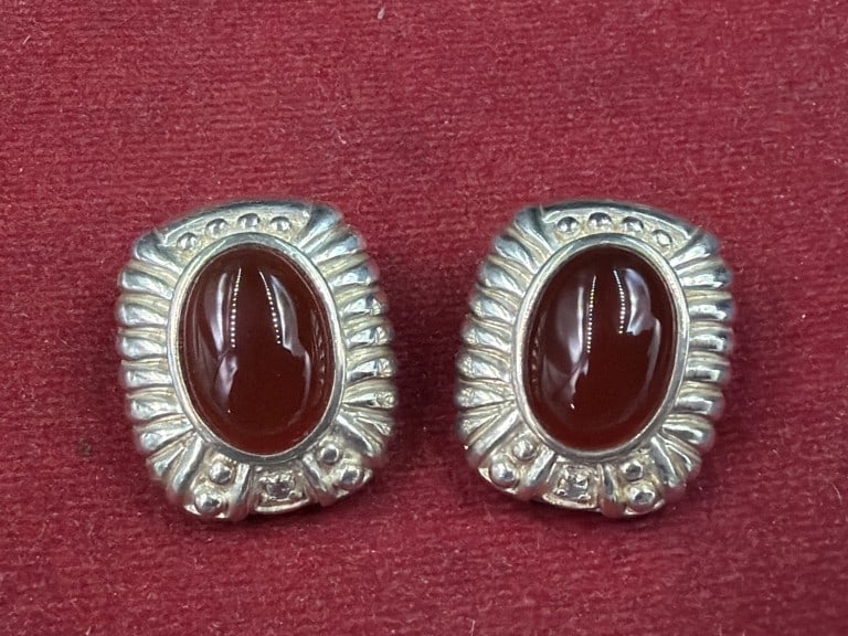 Judith Ripka Sterling Earrings: Sterling silver stud earrings feature oval cabochon stones surrounded by textured, ribbed rope bezel. Weighs 20.2 and condition appears good. No refunds given.