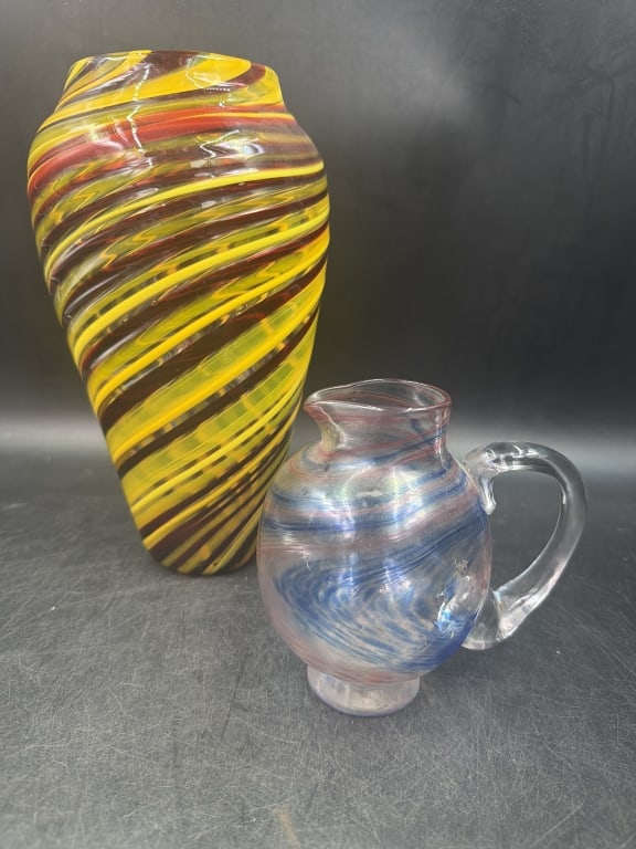 Vintage Glass: Total of 2 in this lot. One is glass pitcher featuring distinct "end of day" swirl pattern of pink, blue and clear tones. Measures 5.5". The other piece is Murano style or Venetian blown glass,