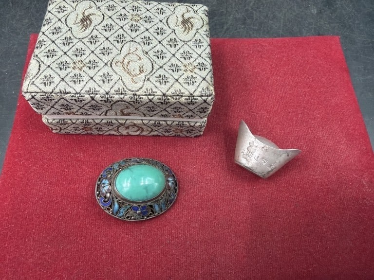 Vintage Chinese Items: One item is a vintage Chinese sycee (8.0 g) which is a traditional boat shaped silver ingot used for currency. The other item a vintage Chinese brooch (11.4g) features intricate silver filigree
