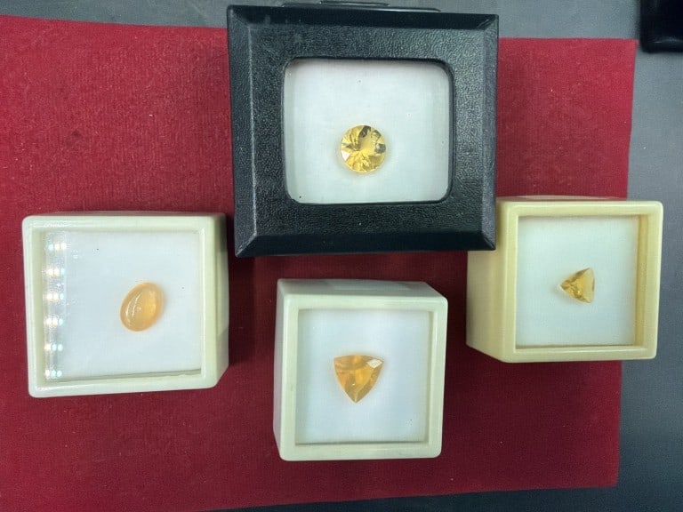 Gemstones: Total of 4 and all in protective cases. All are marked Fire Opal, see pictures. Condition appears good. No refunds given.
