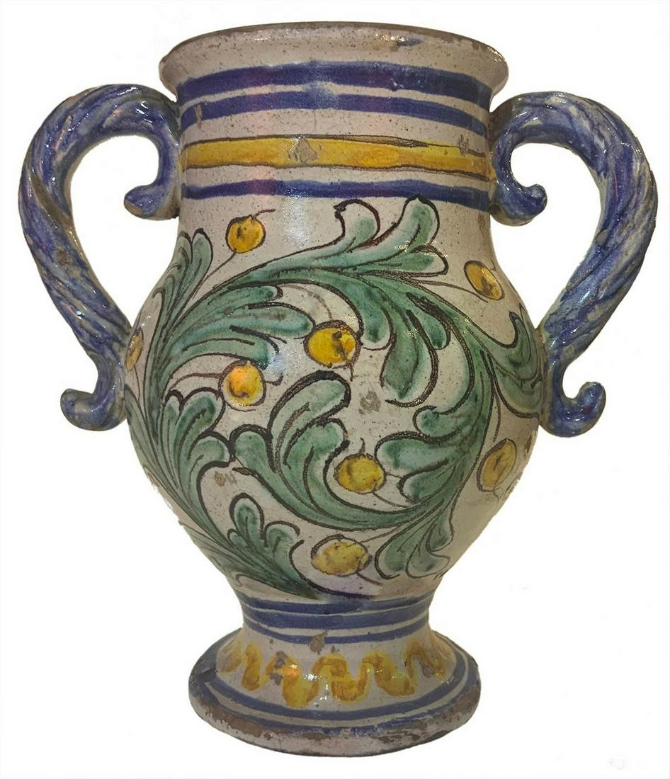 Pitcher with handles and decorations and large green leaves on a white background in majolica from (1 of 4)