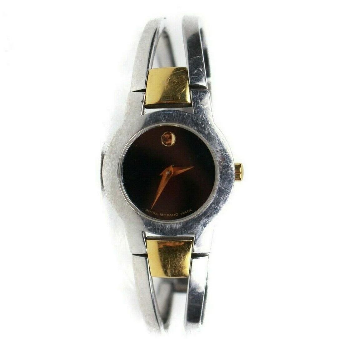 Movado Womens Watch - Gold & Stainless Steel - Sapphire: Movado - Womens Amorosa Watch Color: Silver - Gold Material: Stainless Steel + Gold + Sapphire Diamond Details: item # SN28 Condition: Good Condition, gently used some scratches and wear throughout, s