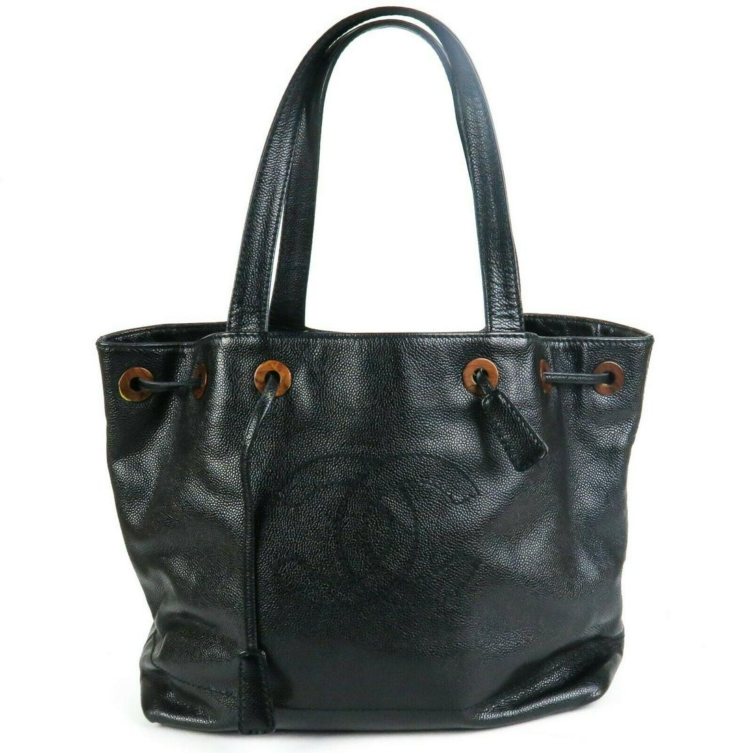 Chanel - Caviar Large Black Tote Bag Drawstring Wood CC: Chanel - CC Caviar Large Black Tote Bag - Drawstring - Large CC Logo Color: Black Size: Large Material: Leather ------------------------------------------------------------ Details: - drawstrings - wo