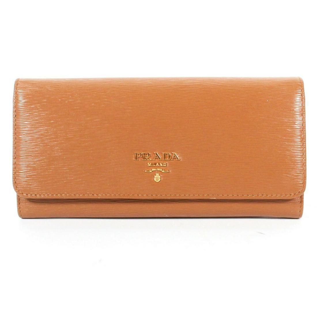 Prada - New - Saffiano Leather Wallet - Logo Color:: Prada - New - Saffiano Leather Wallet - Logo Color: Tan, Gold Material: Saffiano Leather ------------------------------------------------------------ Details: - button clasp - gold Prada Logo - item #