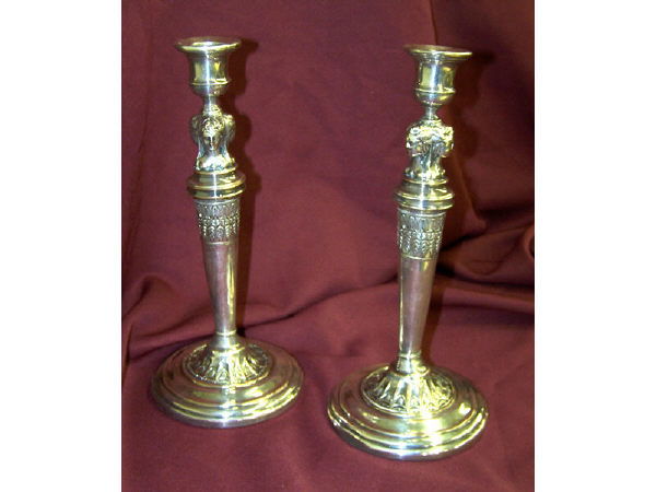 Silver on Copper Minerva Head Candlesticks: 19th century candlesticks, with three Minerva head figures adorning ech. Minor lower rim dent to one candlestick. 8" tall.