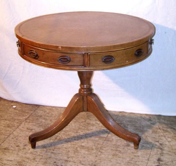 A Good Duncan Phyfe Revival Drum Table: A good light finish mahogany drum table. With a lazy susan rotating top. Lether inset. 34" diameter. Having a drawer and brass feet.
