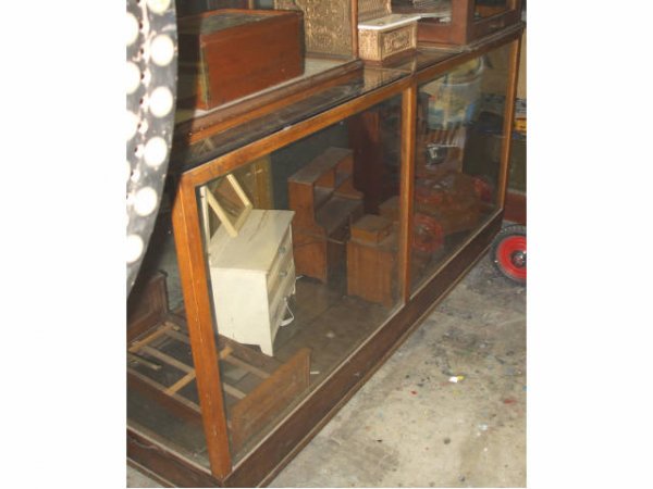 Fine General Store Display Case: A good early 1900s large 7' showcase. Glass adjustable shelves is good used 100 year old condition. Mismtached back door glasses.