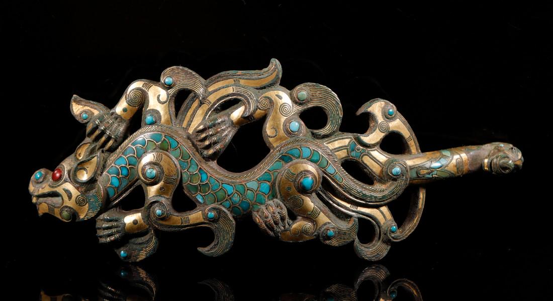 Silvering and Gold Plating Belt Hook inlay with: Silvering and Gold Plating Belt Hook inlay with Turquoise and Two Dragon Heads Design from Zhan Guo Dimensions: H: 1 1/4 in(3.3cm) L: 6 3/4 in(17cm) W: 2 5/8 in(6.8cm) Weight: Wt:263g