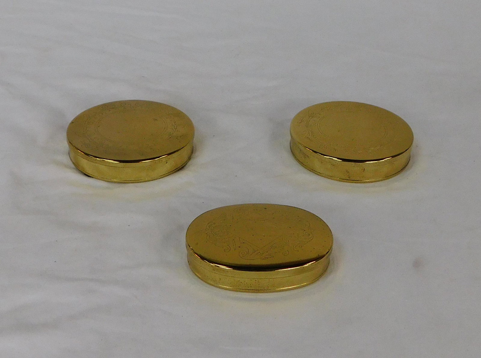 3 Virginia Metalcrafters Brass Boxes: 3 Virginia Metalcrafters Brass Boxes in good condition, All with embossed/engraved lids and felt lined, all marked VM, Oval Box also marked Williamsburg, 2 Round Boxes 4.5''Dia, Oval Box 3.25''DIa