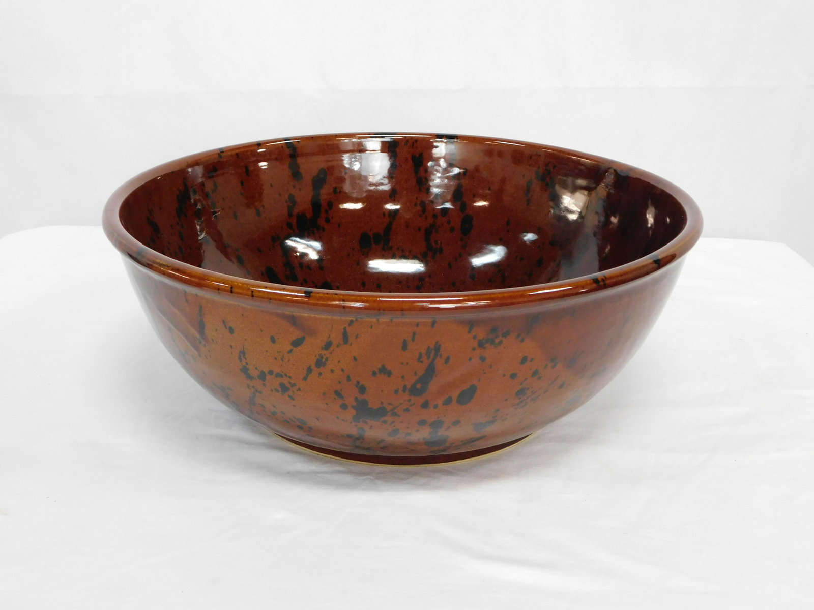Large Mottled Brown Stoneware Bowl: Large Mottled Brown Stoneware Bowl with Script L Mark. 6"H x 16.25"D in good condition.