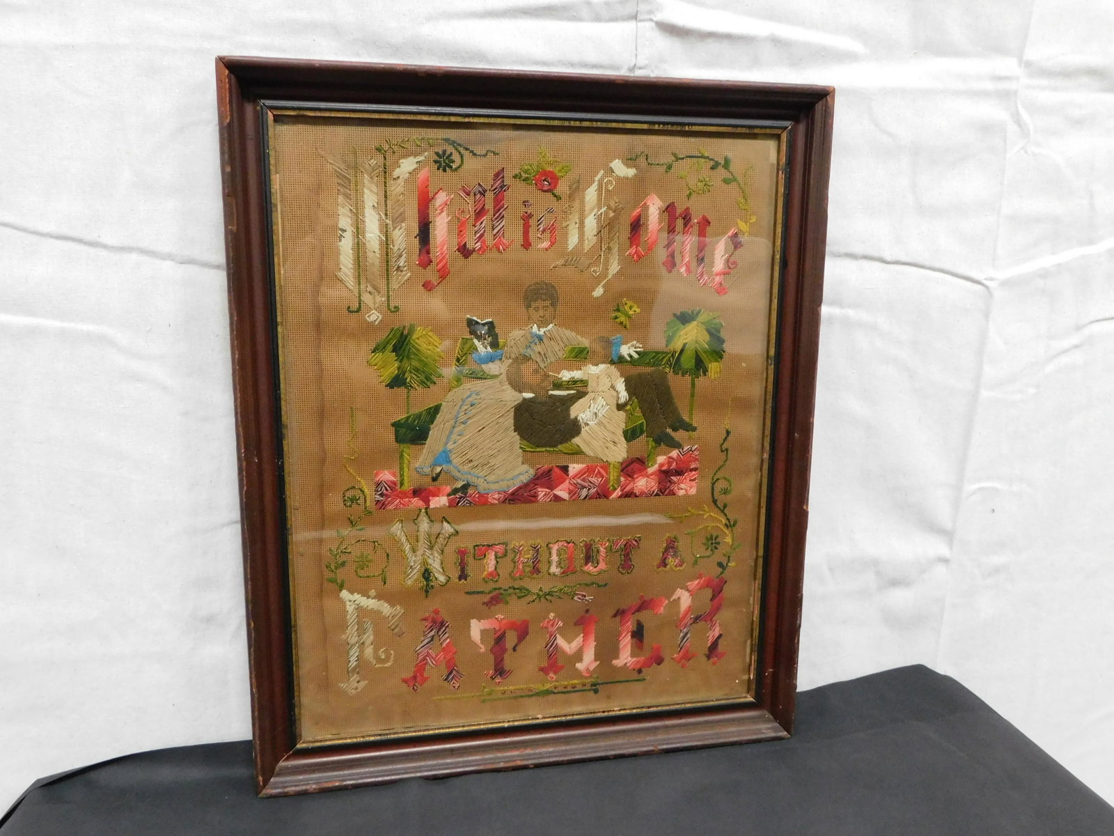 Antique Framed Needlework Sampler: Antique Framed Needlework Sampler "What is Home Without a Father" in good condition with some watermarks. Frame size 22.5" x 18.75"