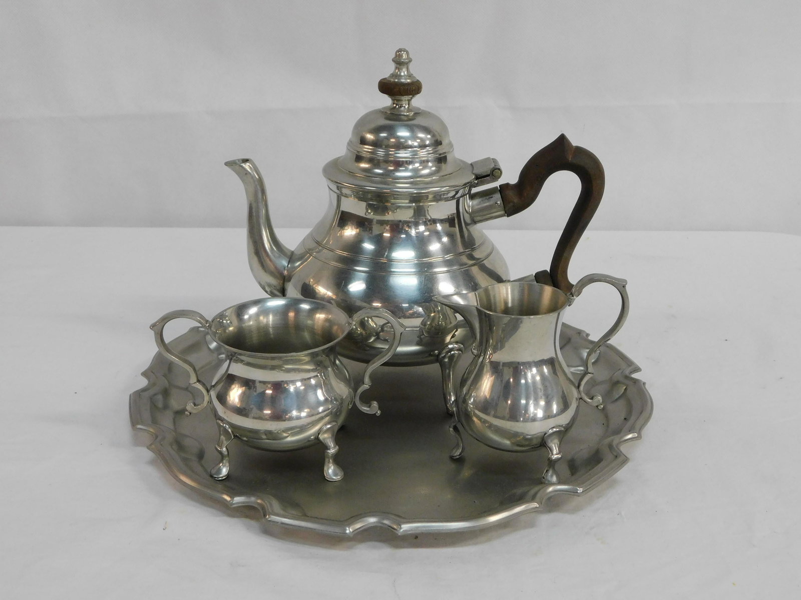 Stieff Pewter Colonial Williamsburg Tea Set: Stieff Pewter Colonial Williamsburg Tea Set, Tea Pot in good condition with damage to handle as pictured, Creamer and Sugar in good condition, Tray in good condition, Tea Pot CW 80-16, Creamer CW 83-1