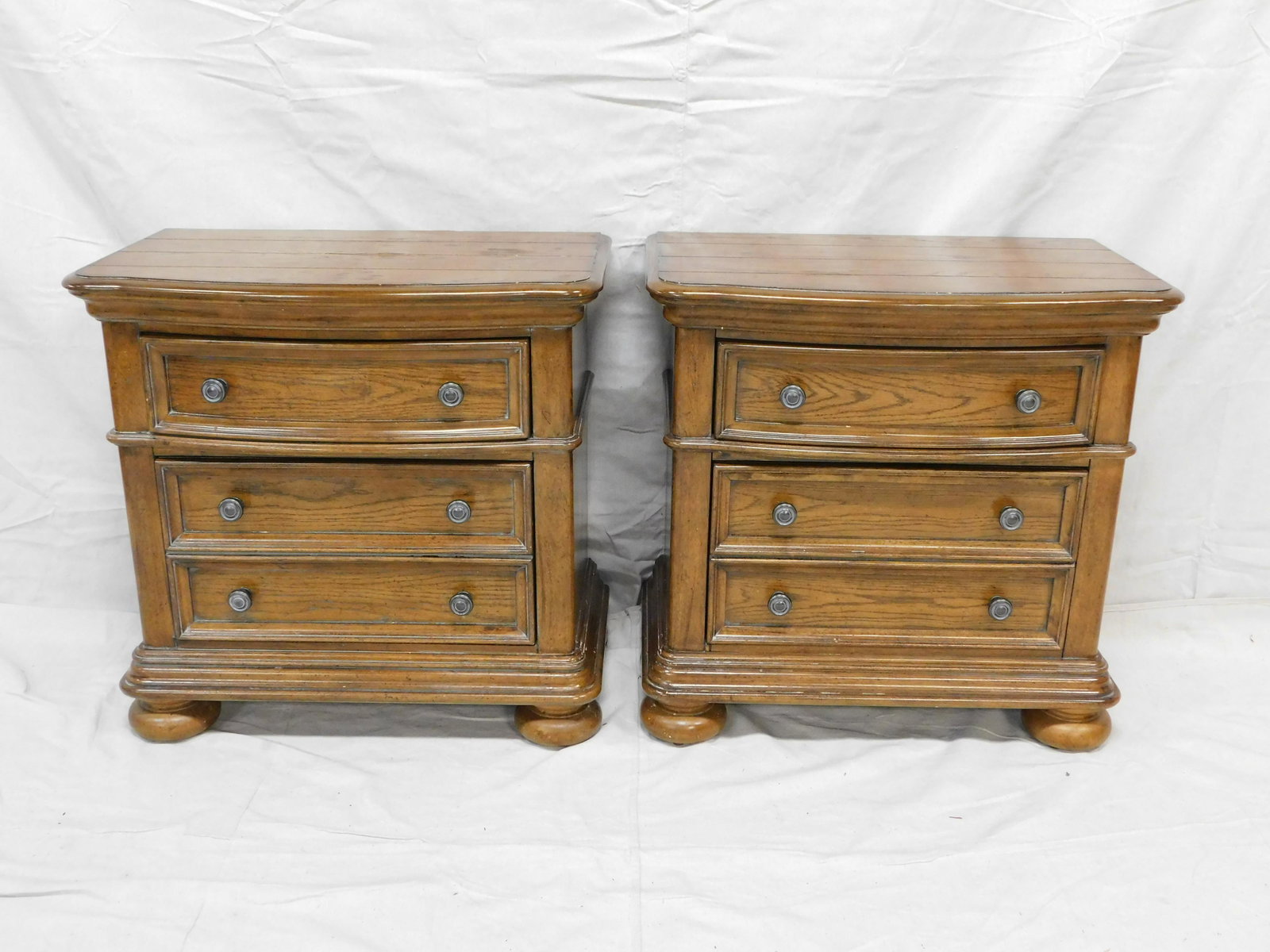 Pair of Modern Three Drawer Oak Nightstands: Pair of Modern Three Drawer Oak Nightstands in good condition with some signs of wear to tops, 29''H x 30''W x 17.75''D ***Auctioneer Note: This is part of a bedroom suite, if interested in matching p
