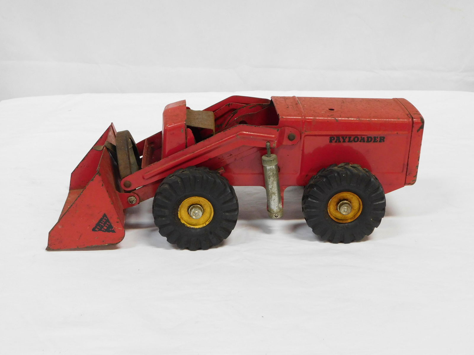Vintage Nylint Houch Payloader Toy Truck: Vintage Nylint Houch Payloader Toy Truck with some parts. The truck rolls and you can manually lift the front loader, but the steering and lever mechanisms are in parts. Unsure if all parts are presen