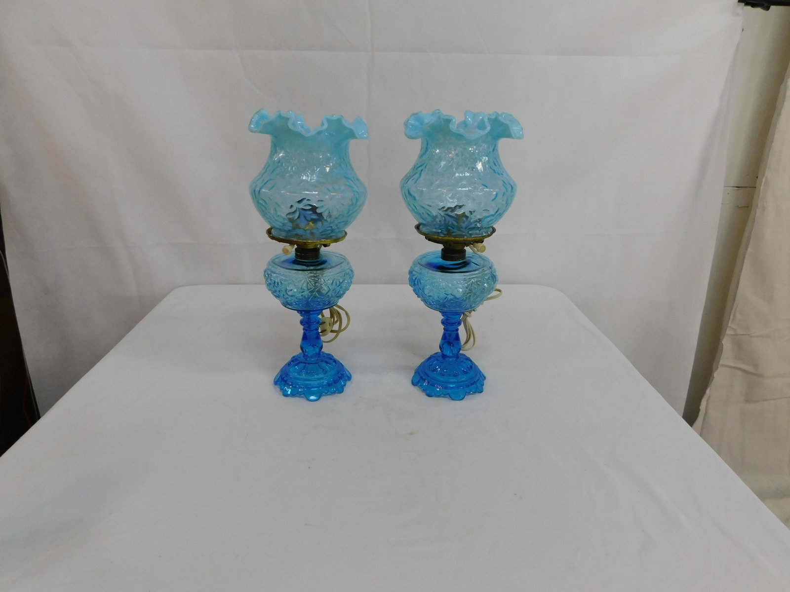 2 Fenton Shade & Button & Daisy Oil Lamps: 2 Fenton Shade & Button & Daisy Oil Lamps. These have been electrified but have not been drilled. The shades are Daisy and Fern. In good condition. Overall height 15.5"