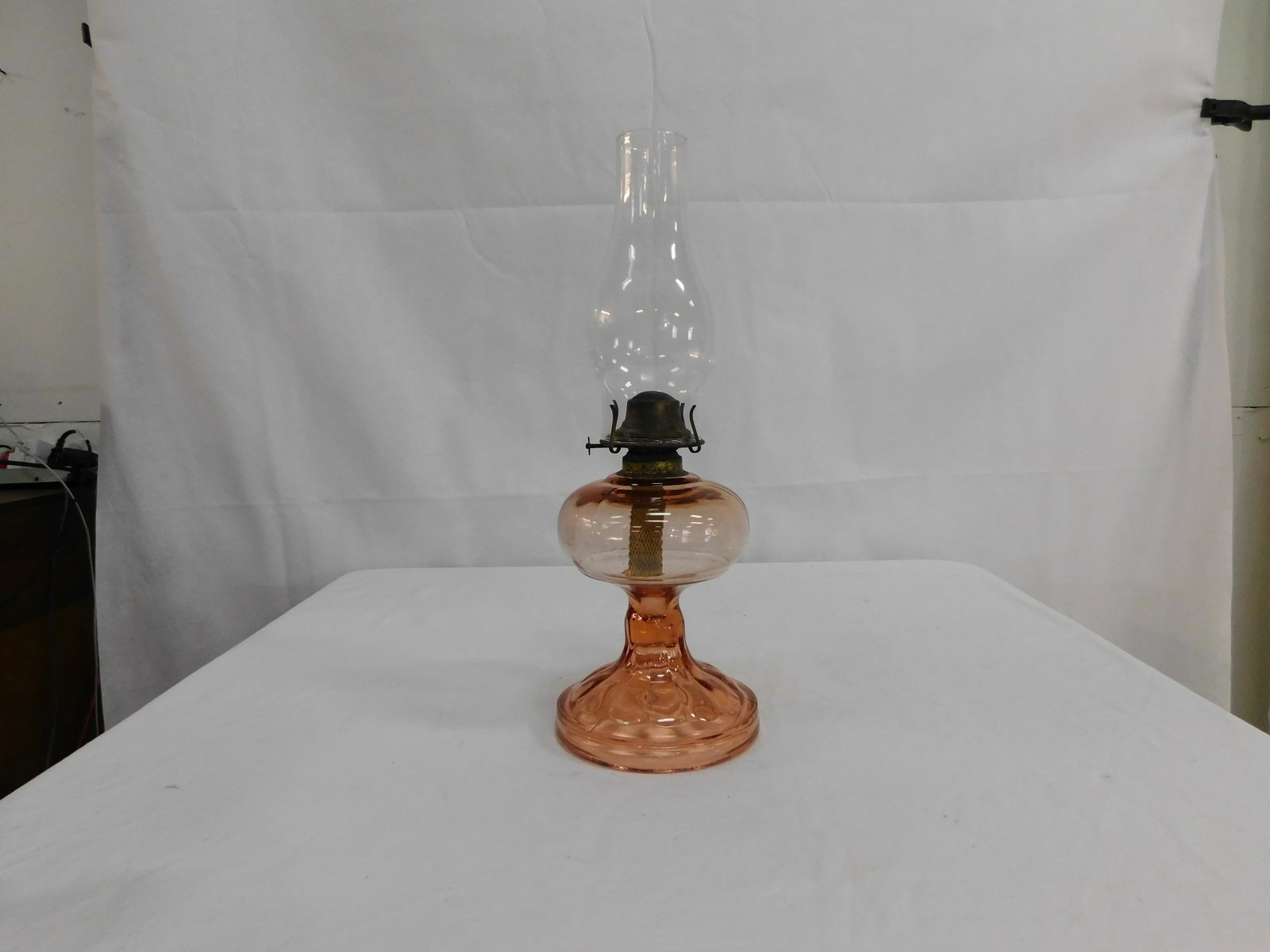 Antique Pink Glass Oil Lamp: Antique Pink Glass Oil Lamp in good condition with some roughness around the edge of the base. Overall height 17.25"