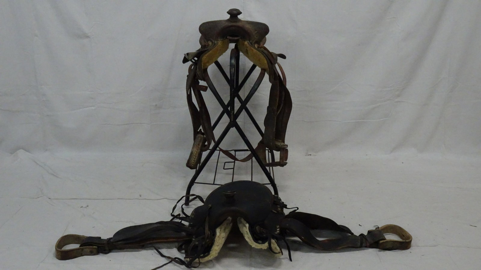 Two Leather Saddles and Stand: Two Leather Saddles and Stand, in good condition,