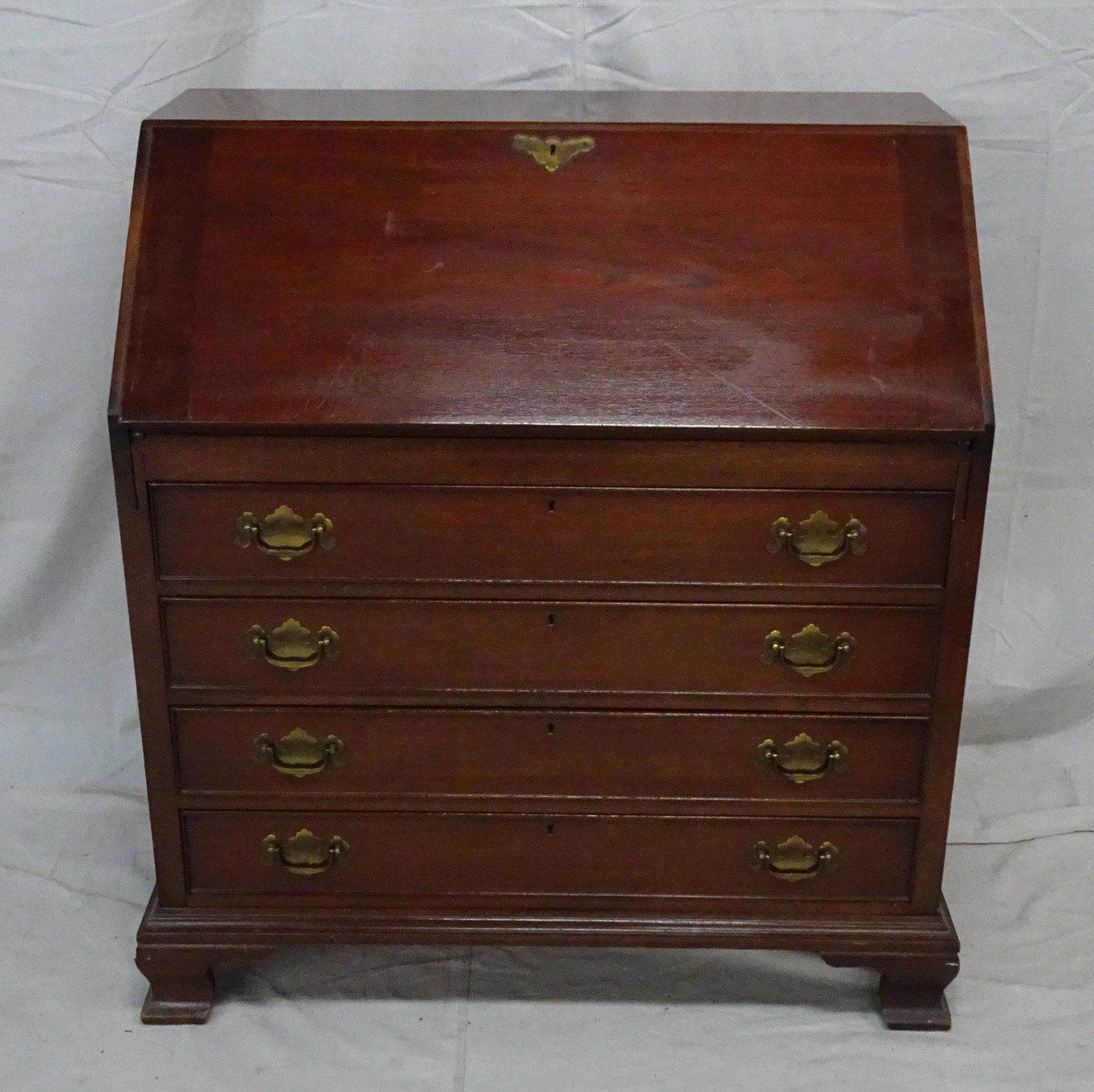 Traditional Chippendale Mahogany Drop Front Desk: Traditional Chippendale Mahogany Drop Front Desk in good condition, dovetailed drawers, fitted interior, individually locking drawers, bracket feet, 40''H x 36''W x 21''D