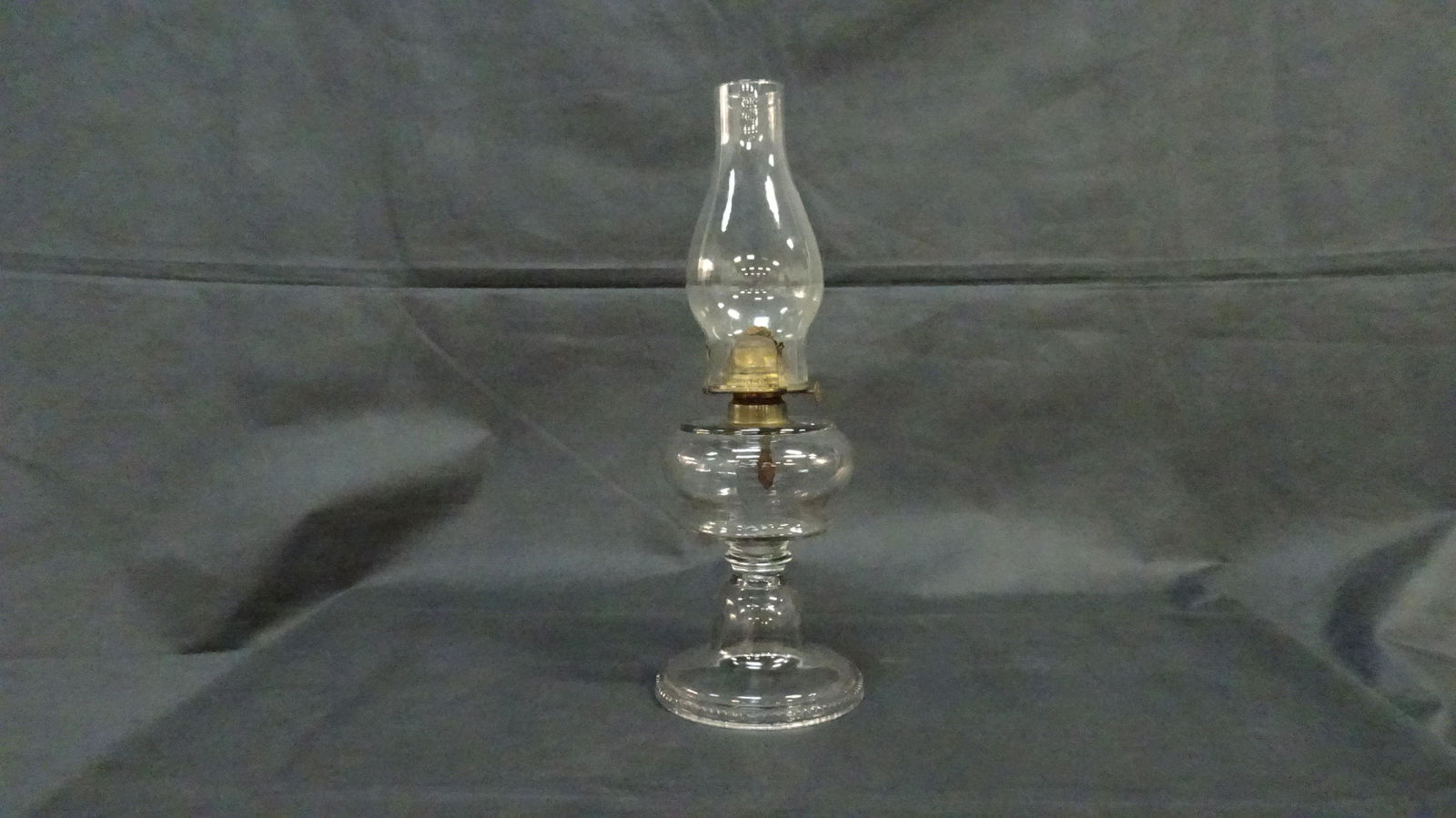 Early Oil Lamp: Early Oil Lamp with flattened font drip collar scalloped edge on base in good condtion with some roughness around the base. Hinged brass Banner burner. Over all height with chimney 18"
