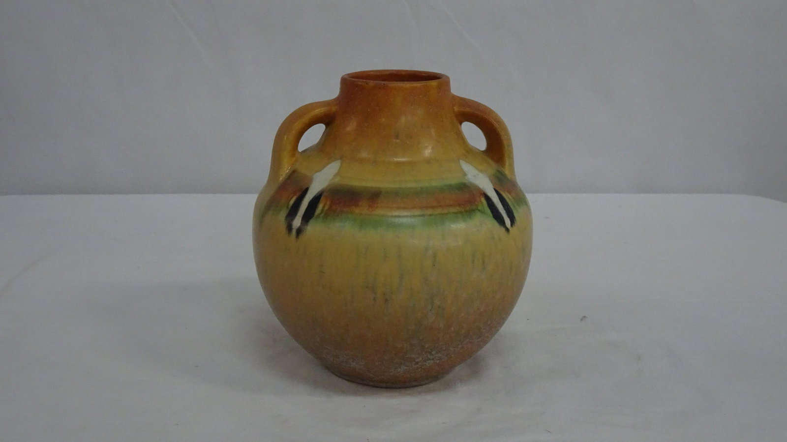 Rare Montacello 1931 Roseville Pottery Vase 562-7: Rare Montacello 1931 Roseville Pottery Vase 562-7. An American art pottery vase by Roseville. Montacello / Monticello pattern. Bulbous shaped double handled vase having a Southwest Native American mot