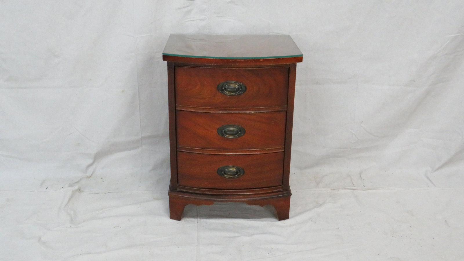 Vintage Dixie Mahogany Bowfront Night Stand: Vintage Dixie Mahogany Bowfront 3 Drawer Night Stand in good condition, some wear consistent with age, protective removeable glass top, dovetailed drawers, brass hardware, 25.5"H x 18.5"W x 15"D