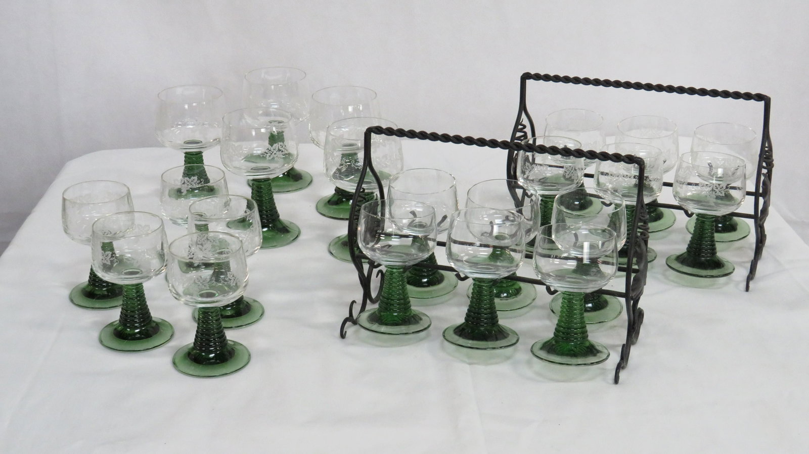 22 Vintage Green Stem Wine Glasses 2 Caddies: 22 Vintage Green Stem Wine Glasses 2 Caddies in good condition. Eleven small etched, 5 large etched, 6 small with no etching, and 2 metal caddies.