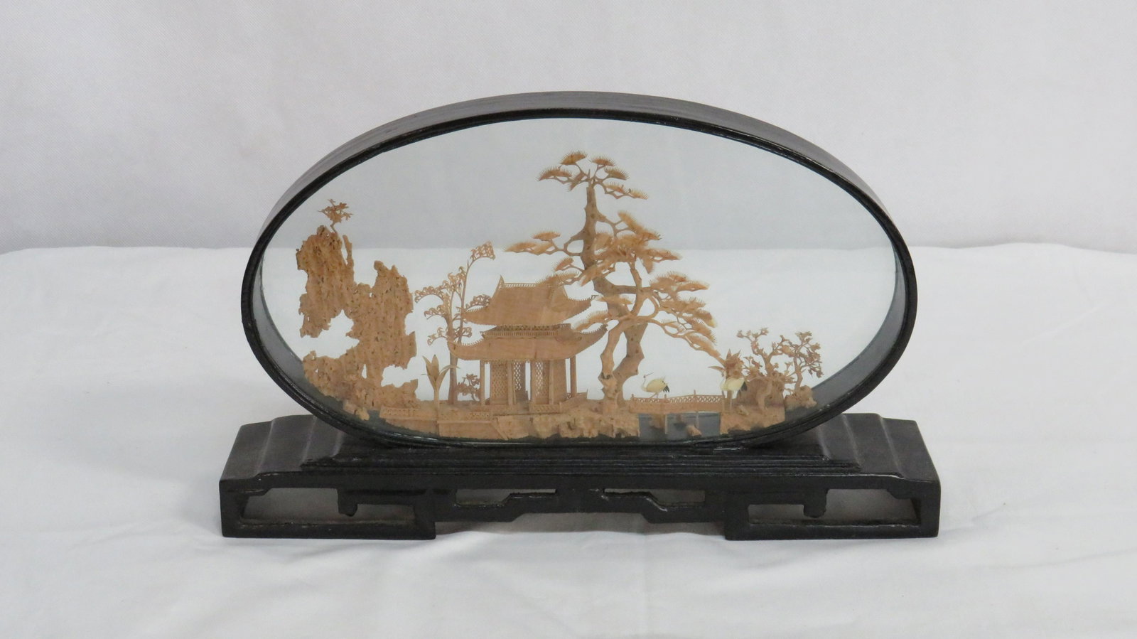 Vintage Hand Carved Cork Diorama Glass Case: Vintage Hand Carved Cork Diorama in Glass with black laquer frame and base in good condition. Very detailed Chinese landscape scene with a pagoda and trees with white stork like birds. Encased in a bl