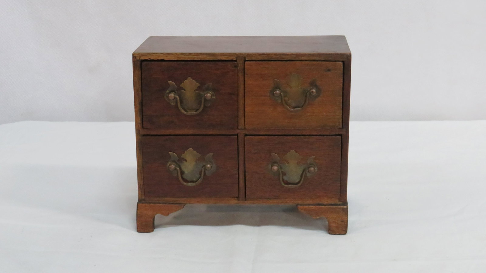 Miniature Mahogany Bracket Foot Chest of Drawers: Miniature Mahogany Bracket Foot Chest of Drawers in good condition. Traditional chippendale brass bolt on pulls. 7.5"H x 9"W x 5.25"D