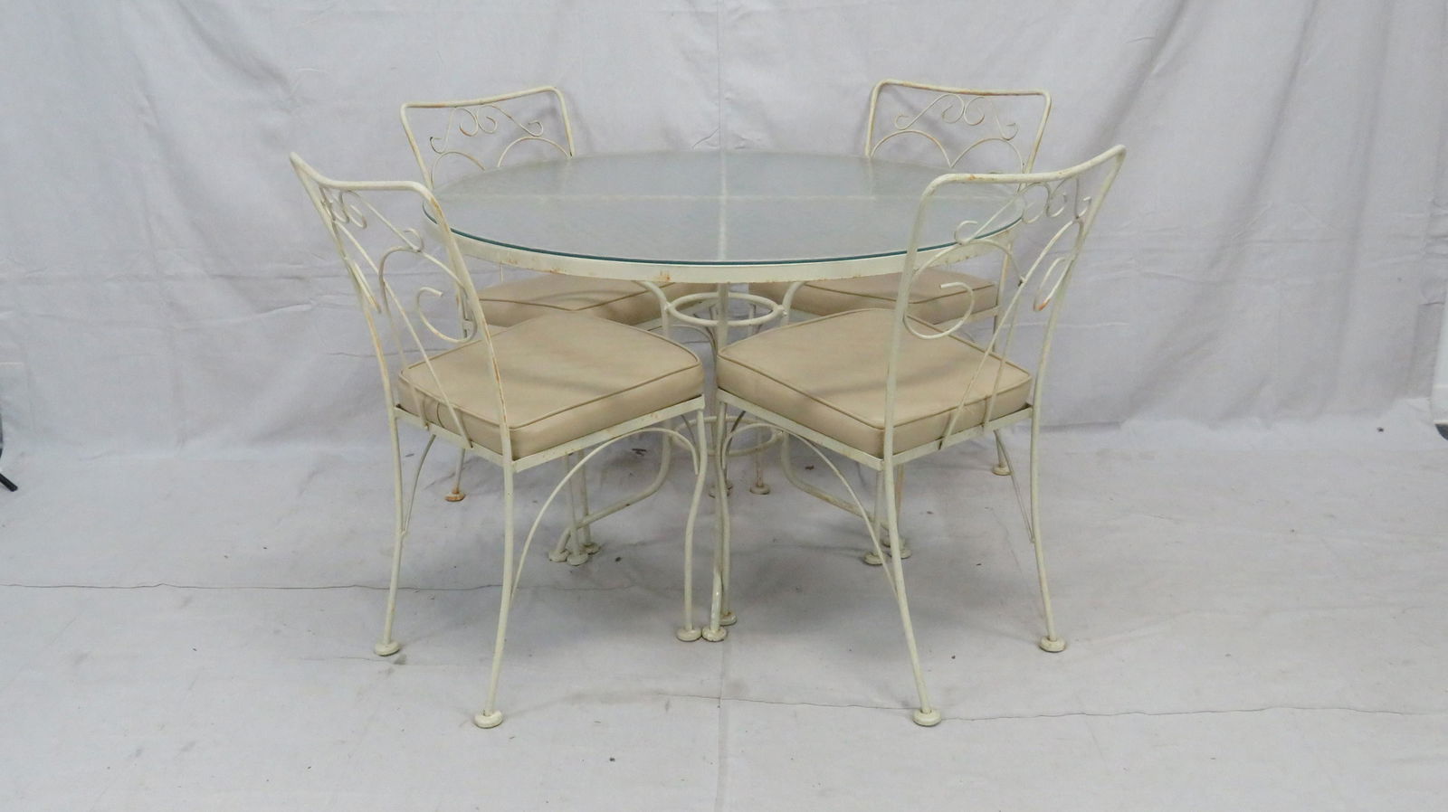 Vintage Wrought Iron Table and Chairs: Vintage Wrought Iron Table and Chairs in good condition, with cushioned seats, Table 28.5''H x 42''Dia, Chairs 33''H x 17.5''W x 22''D