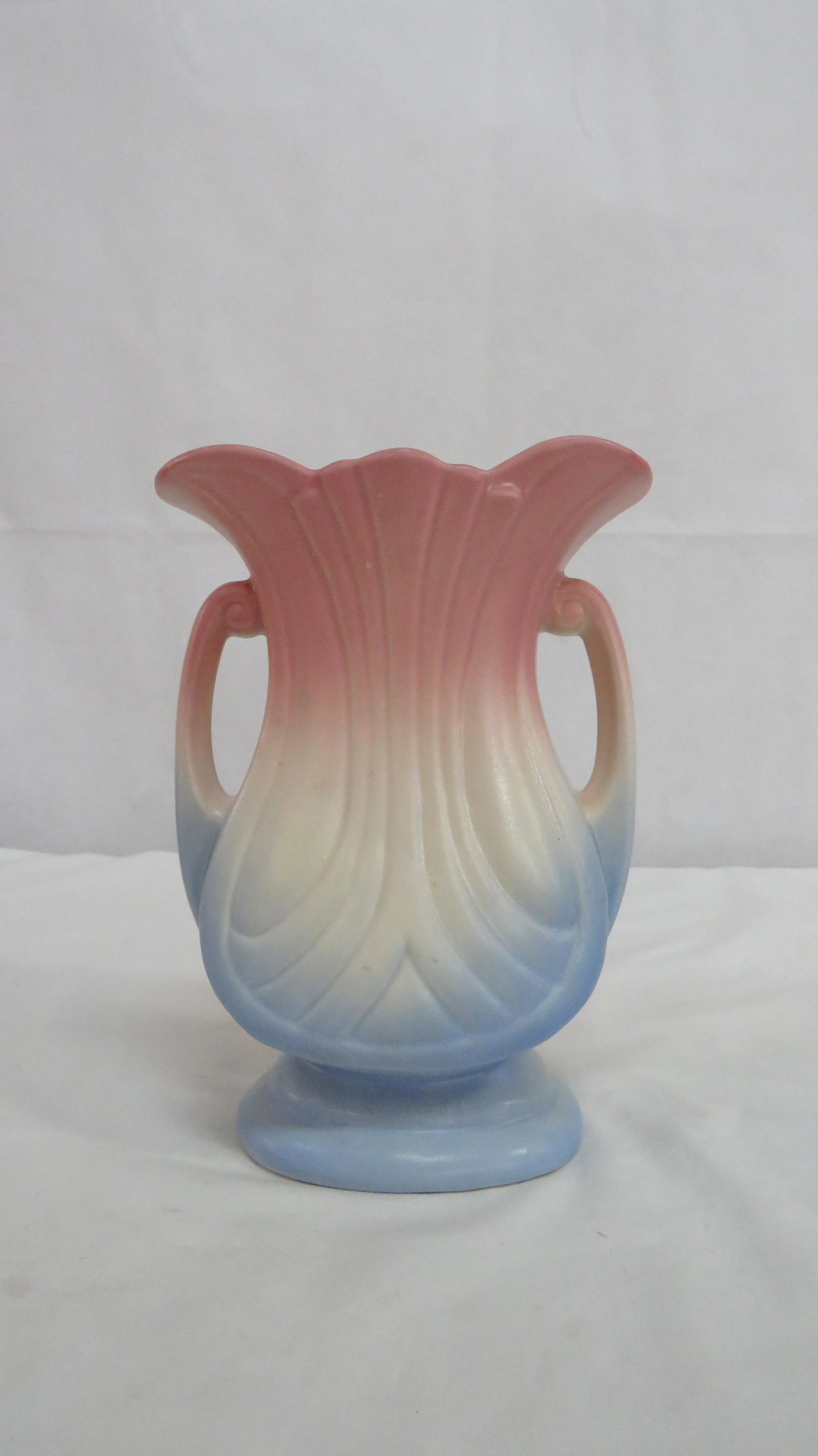 Hull Pottery Mardi Gras Vase: Hull Pottery Mardi Gras Vase in good condition. There is one spot on the rim that appears to have touch up color. 9"H