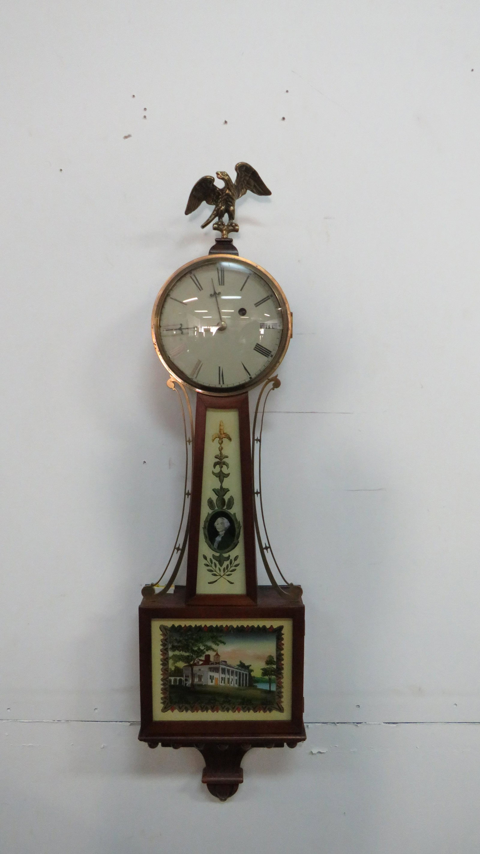 Quality Replica E. Howard Banjo Clock One Weight: Quality Replica E. Howard Banjo Clock One Weight in good condition. Reverse painted scenes of George Washington and Mt. Vernon on the glass with brass eagle finial in a nice mahogany case. Running whe