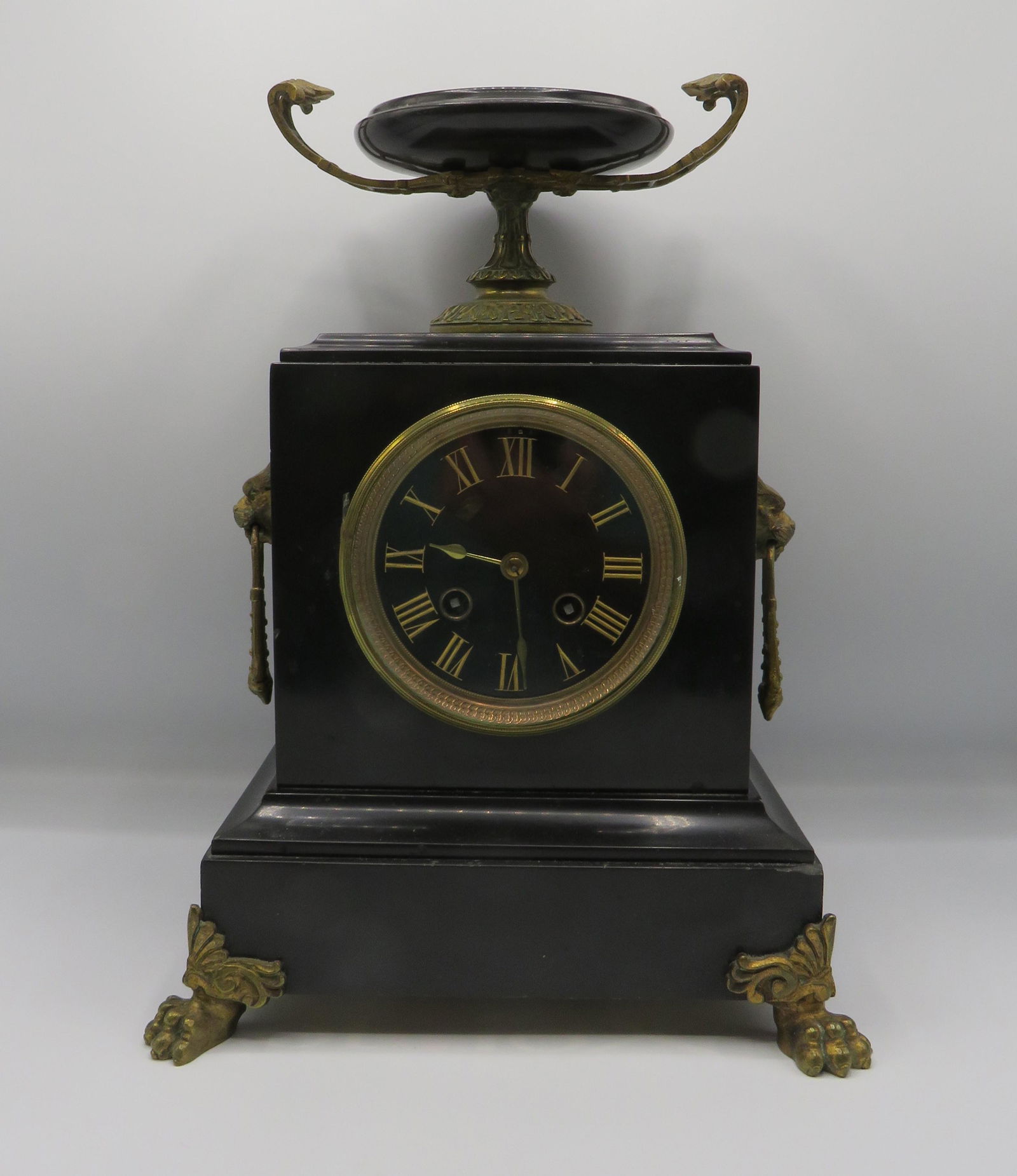 French Empire S Marti Medaille De Bronze Clock: French Empire Samuel Marti Medaille De Bronze Mantel Clock. Guilded metal decoration in a black slate case. Lion's heads on the sides with paw feet on the front. Center profile medallion on the top. B