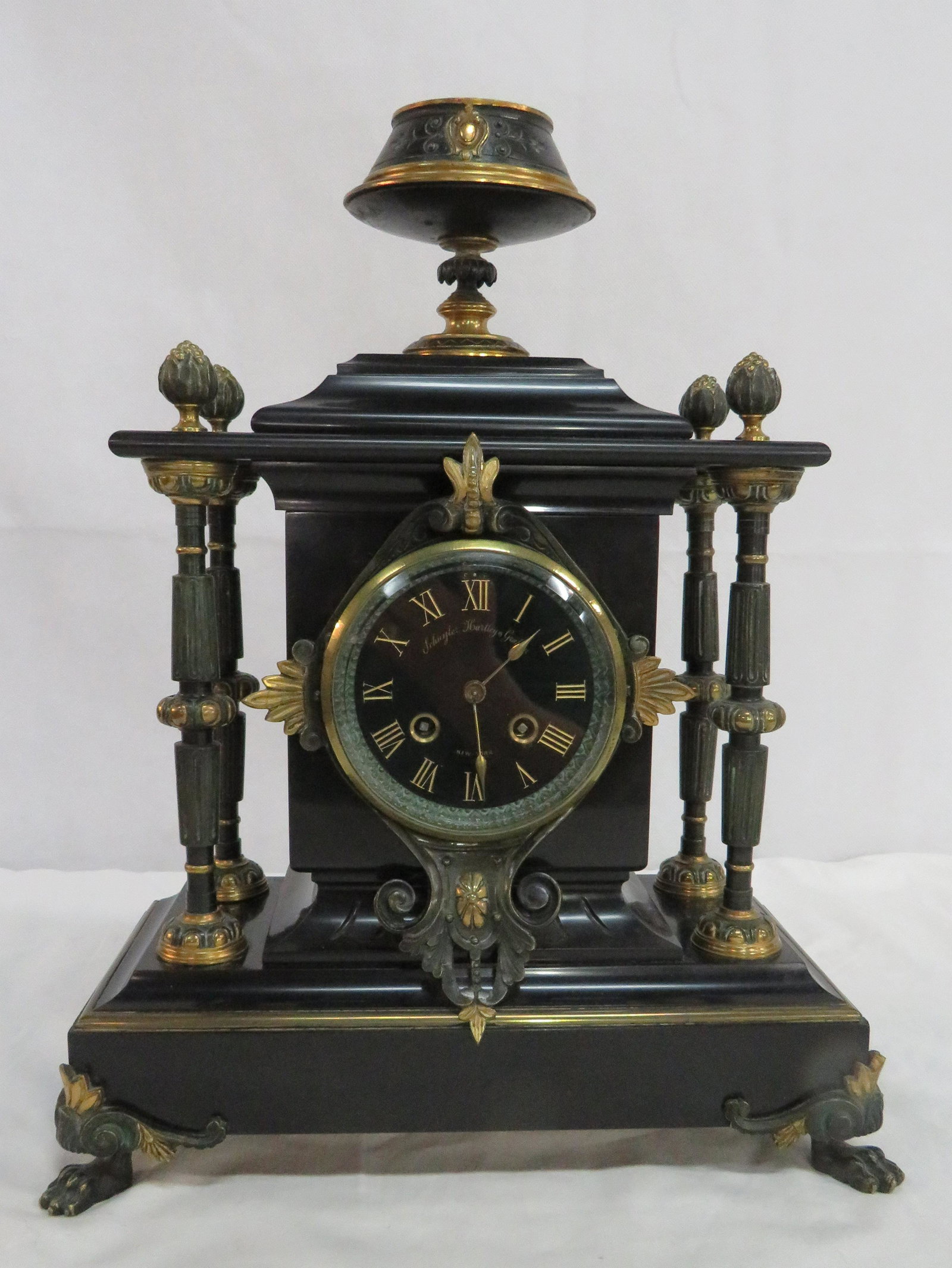 Schuyler Hartley Graham Freres French Clock: 19th Century Marble and Bronze Schuyler Hartley & Graham French Neoclassical Clock with Japy Freres Movement in good condition. Acanthus columns with paw feet. Beveled glass bezel on front, back bezel