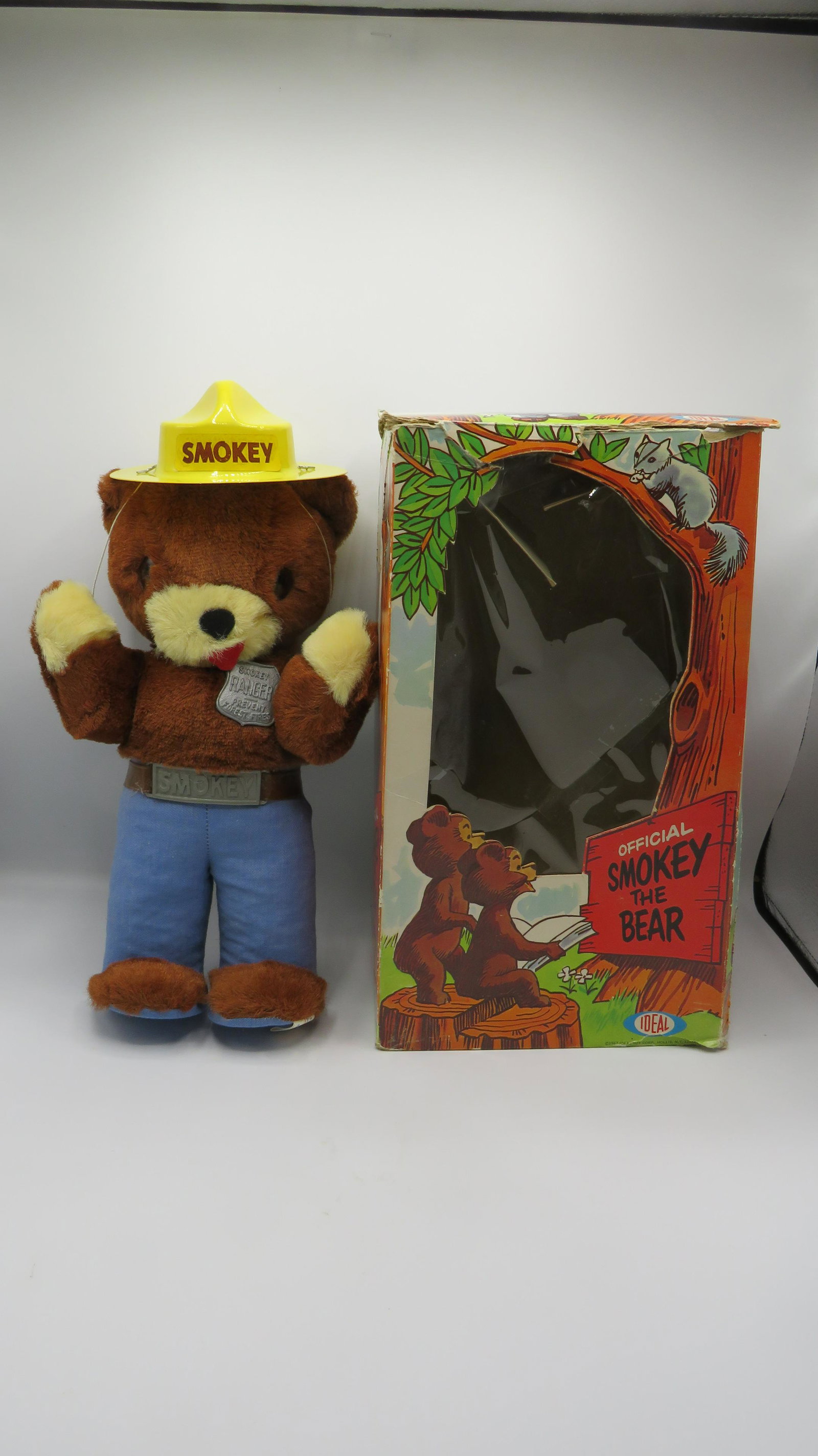 1967 Ideal Smokey the Bear Doll Original Box: 1967 Ideal Smokey the Bear Doll Original Box in good condition. Box shows signs of shelf wear. Comes with hat, badge, and Junior Forest Fighter Rules sheet. Box 14"H x 8"L x 5.5"W