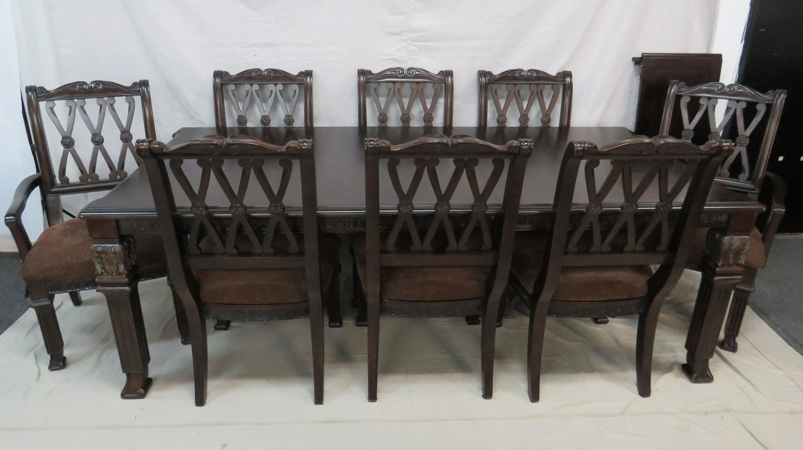 Contemporary Dining Table and Eight Chairs: Contemporary Dining Table and Eight Chairs in good condition, table has two leaves, Carved Table Skirt and Legs, Two Captains Chairs and Six Side Chairs, Chairs have Wide Seats, Table 74'' Long with T