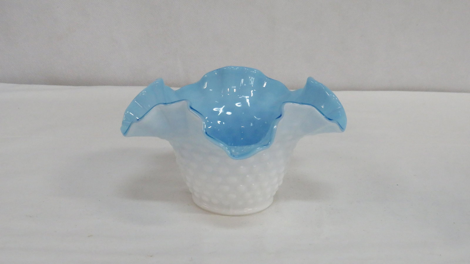 Vintage Fenton Hobnail Cased Glass Ruffled Bowl: Vintage Fenton Hobnail Cased Glass Ruffled Bowl in good condition. White exterior with blue interior. 3.5"H x 6.5"D