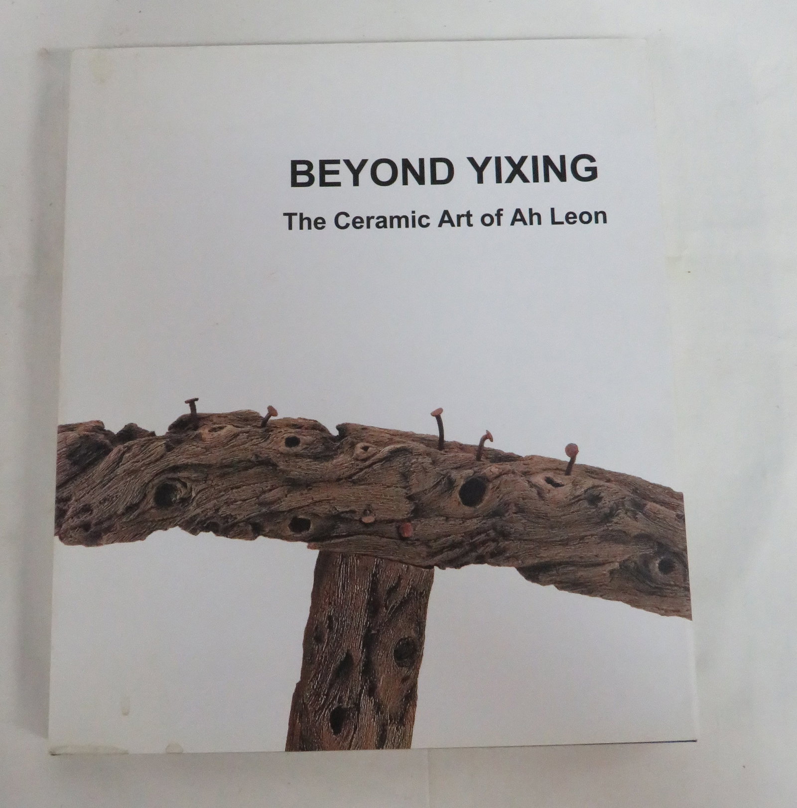 Beyond Yixing Ceramic Art of Ah Leon Book: Beyond Yixing Ceramic Art of Ah Leon Book in good condition. Inscribed and dated by Ah Leon. 146 Illustrations with fold outs. Some light soiling on dust jacket. 11.75" x 10.25"