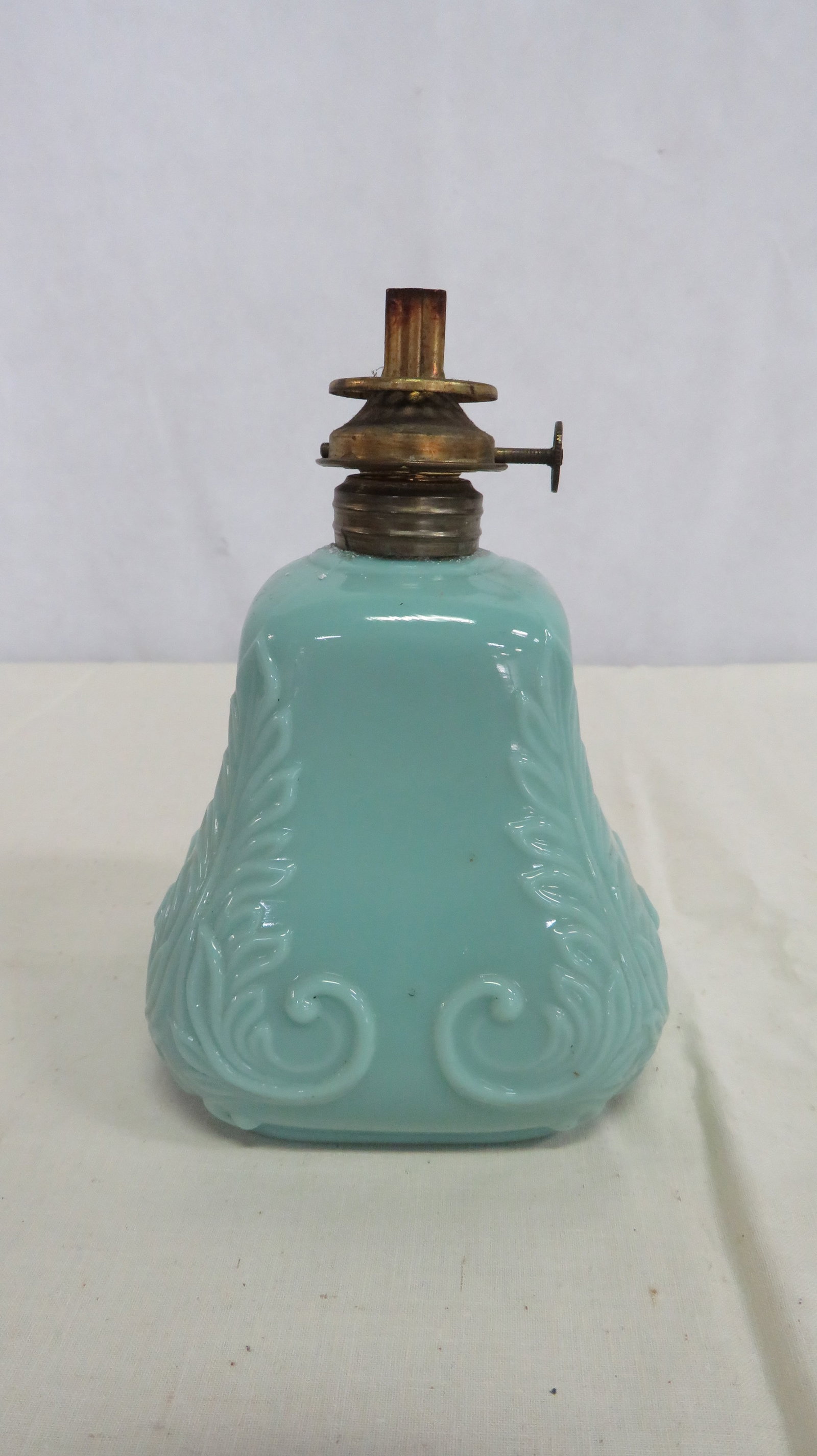 Antique Minature Defender Gillinder Oil Lamp: Antique Minature Defender Gillinder Oil Lamp. Good condition with burner unattached. Turquoise color opaque glass made by Gillinder & Sons of Philadelphia in the 19th century. Overall height 5.5" x 3.