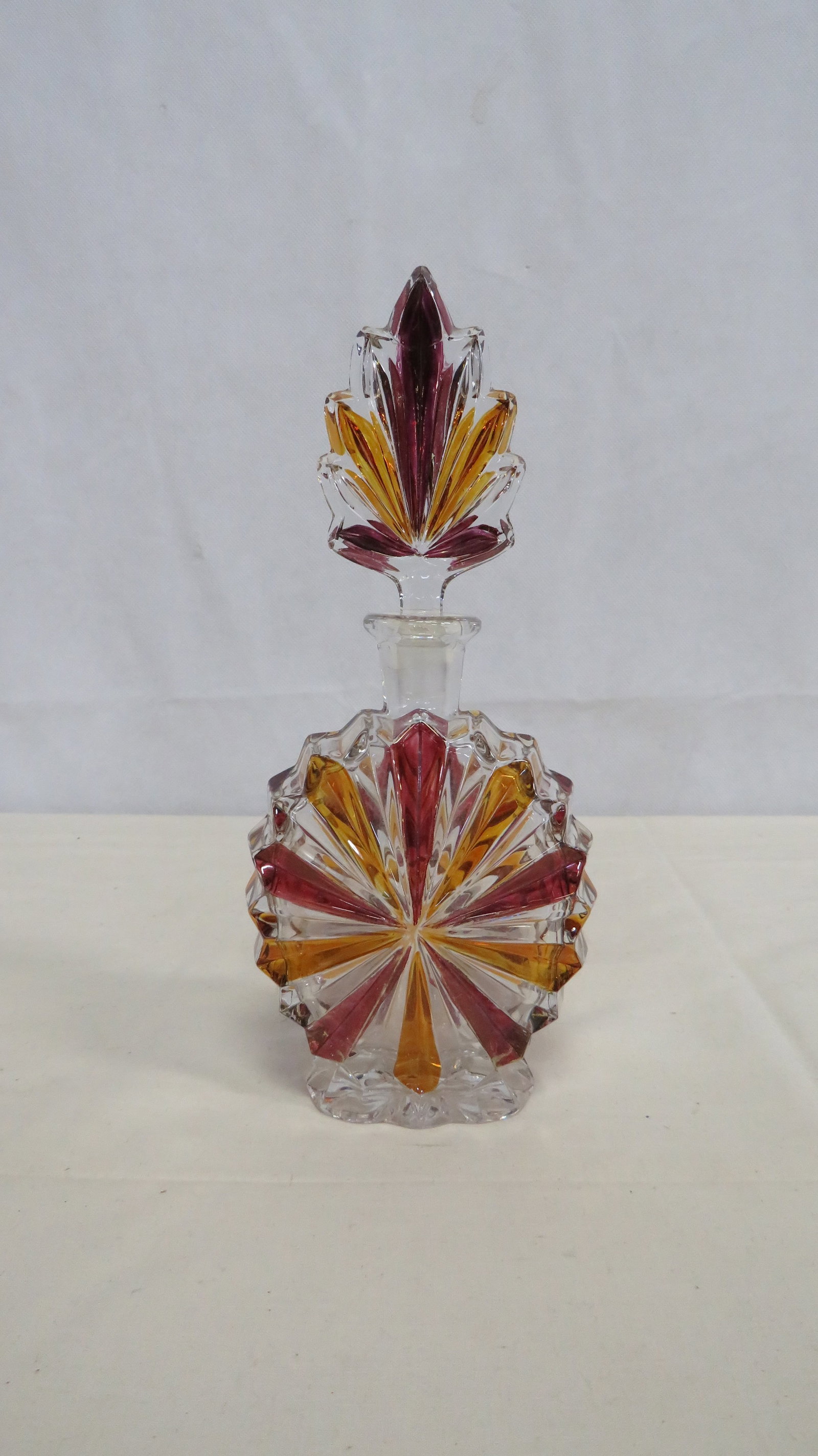Vintage Czech Art Deco Large Perfume Bottle: Vintage Czech Art Deco Large Perfume Bottle in good condition. Crystal bottle with ruby and aber accents. 9.5"H x 4"L x 2.5"W