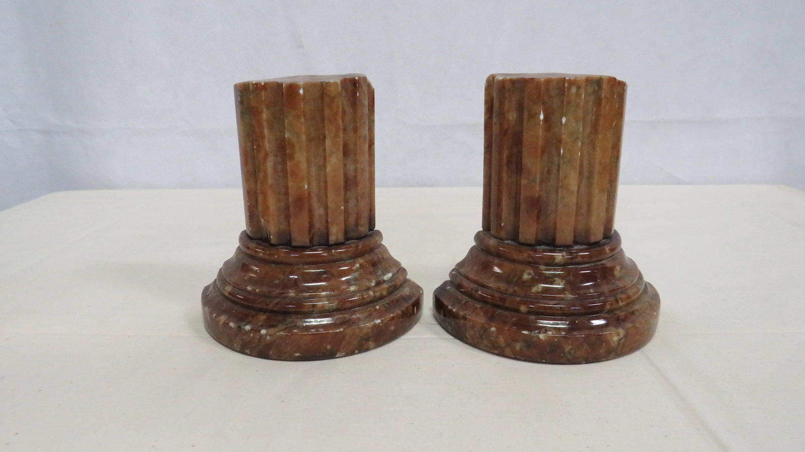 Mid Century Italian Alabaster Column Bookends: Mid Century Italian Alabaster Column Bookends. Some edge chips. 5.75"H x 5.5"L x 2.5"W